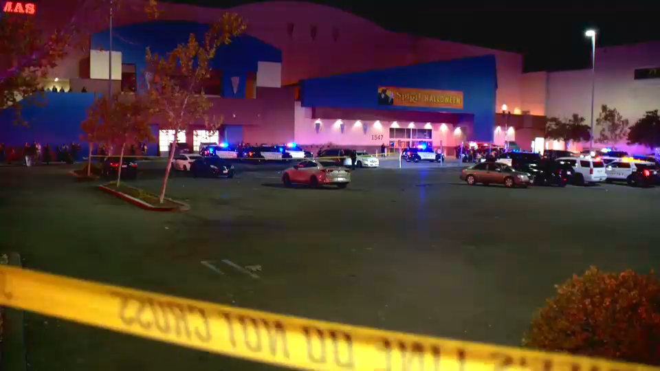 A Spirit Halloween store decorated for Halloween with children and families shopping.